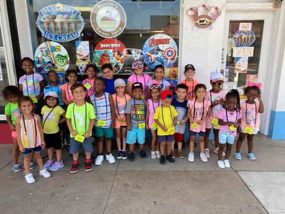 ABOVE: I scream - you scream - we all scream - for ice cream! After a week of learning about how ice cream is made and doing lots of ice cream crafts, Creative Minds Childcare took a walk with the older children downtown to Martin’s Sweet Shop to enjoy Blue Bell Ice Cream. Courtesy photo