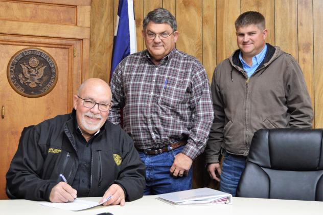 County Judge Joe Fauth is all smiles as he signs the contract with Collier Construction, LLC for the new $10,455,000 million justice center adjacent to the Grimes County Law Enforcement Center on FM 149 West. Michael Collier seals the deal with his signature while son and partner, Clayton Collier, looks on.