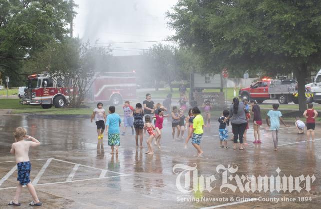 Children had a blast playing in water provided by Navasota Fire Department Monday afternoon, June 28, for “Wet and Wild Day” hosted by Navasota Public Library. Follow the Navasota Public Library Facebook page for more cool summer events. Examiner photos by Celeste Anguiano